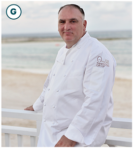 José Andrés wears a chef's shirt. He is near a beach.